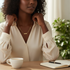 Reneax and Company gold paperclip chain necklace with a minimalist name plate worn by a woman at a desk