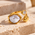 Reneax and Company gold-tone adjustable statement ring featuring an irregular faux pearl and a sparkling cubic zirconia.