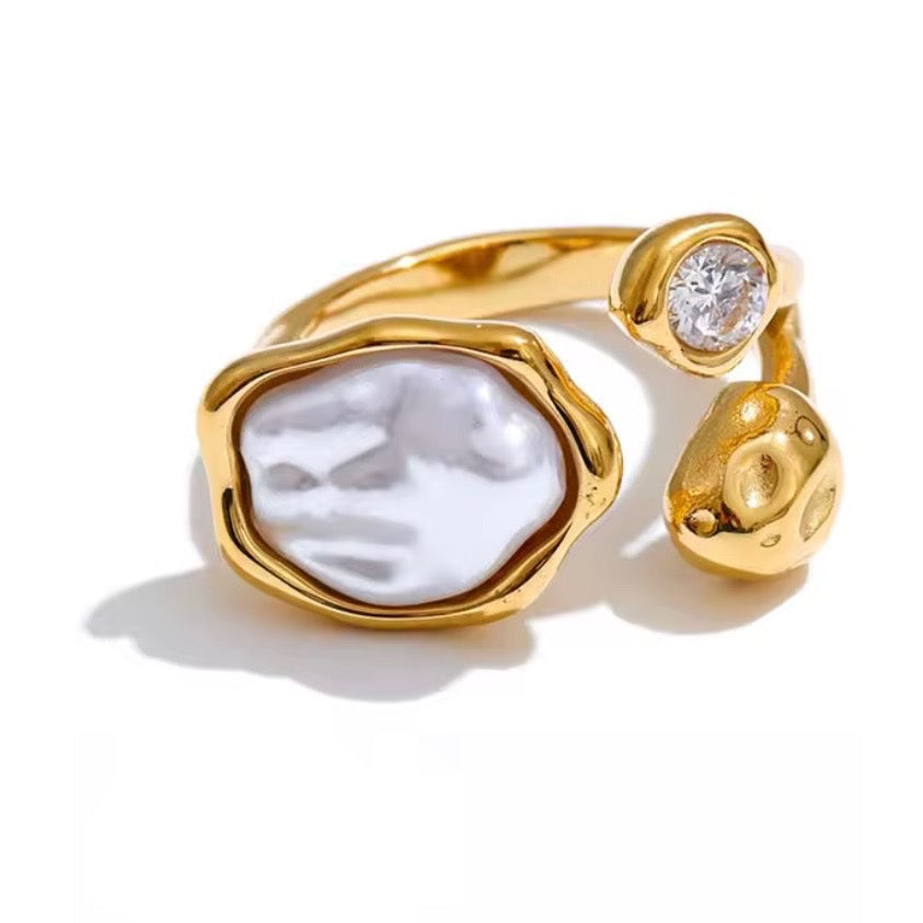 Reneax and Company gold-tone adjustable ring with an irregular faux pearl, cubic zirconia, and molten metal texture.