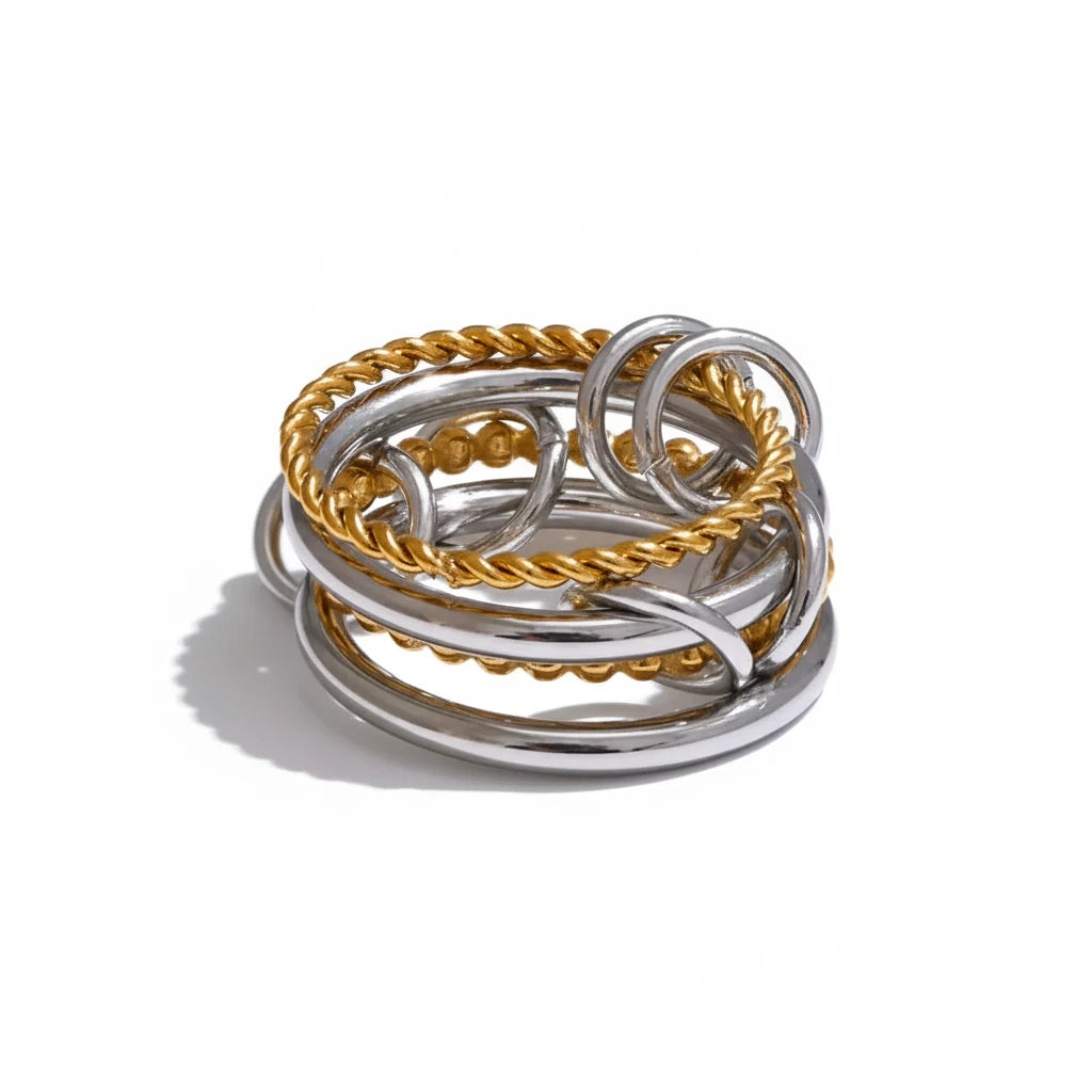 Reneax and Company interlocking multi band statement ring featuring polished silver and twisted gold rope textures.
